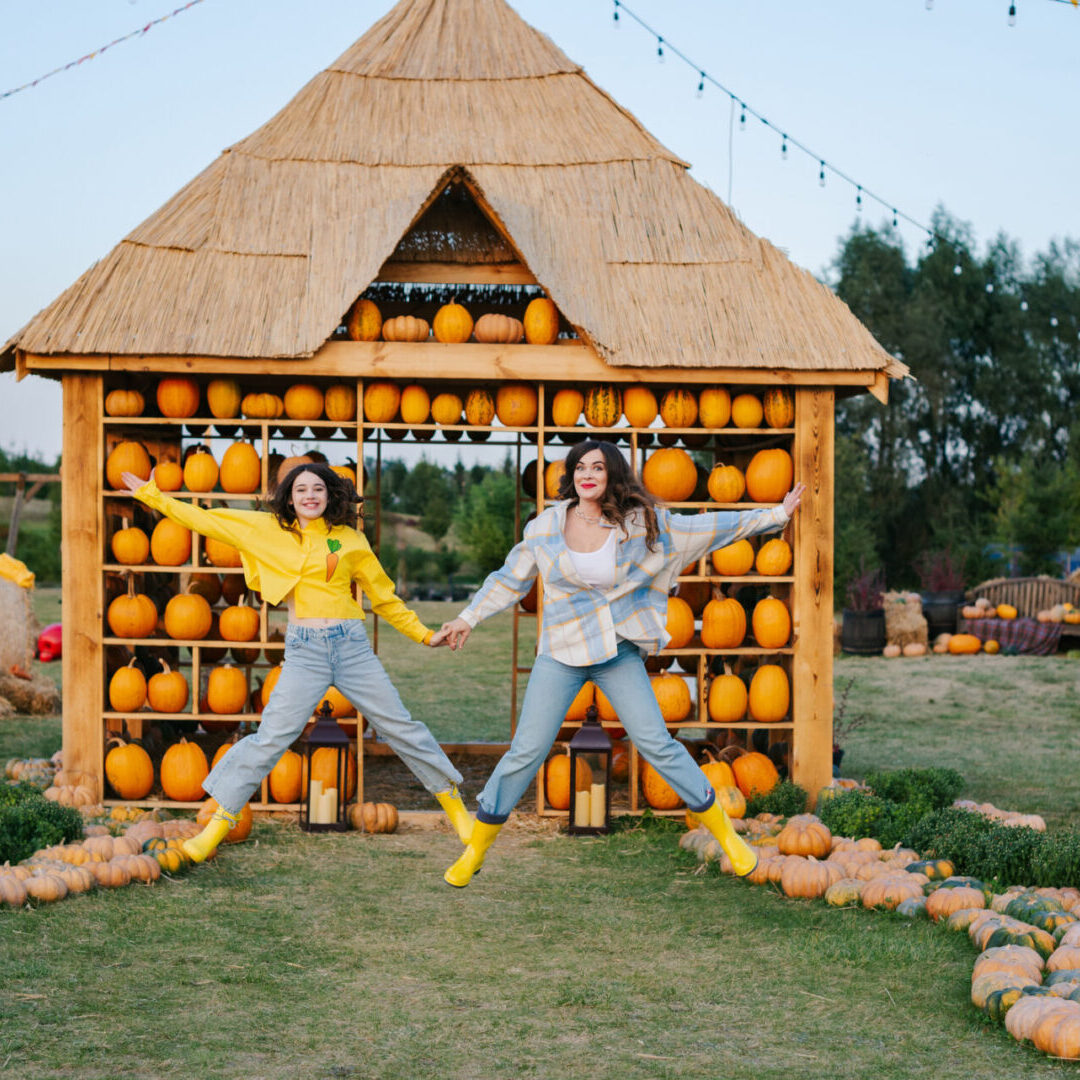 Pumpkin picking. Family gathering autumn vegetable harvest on farm. Worker holding big pumpkin in field. Halloween. Thanksgiving.